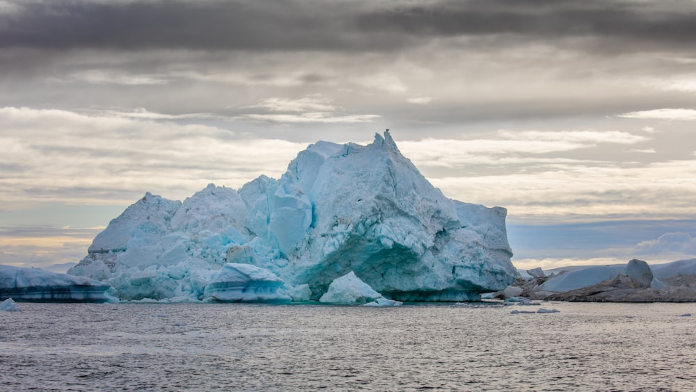 a large iceberg floating on top of a body of water