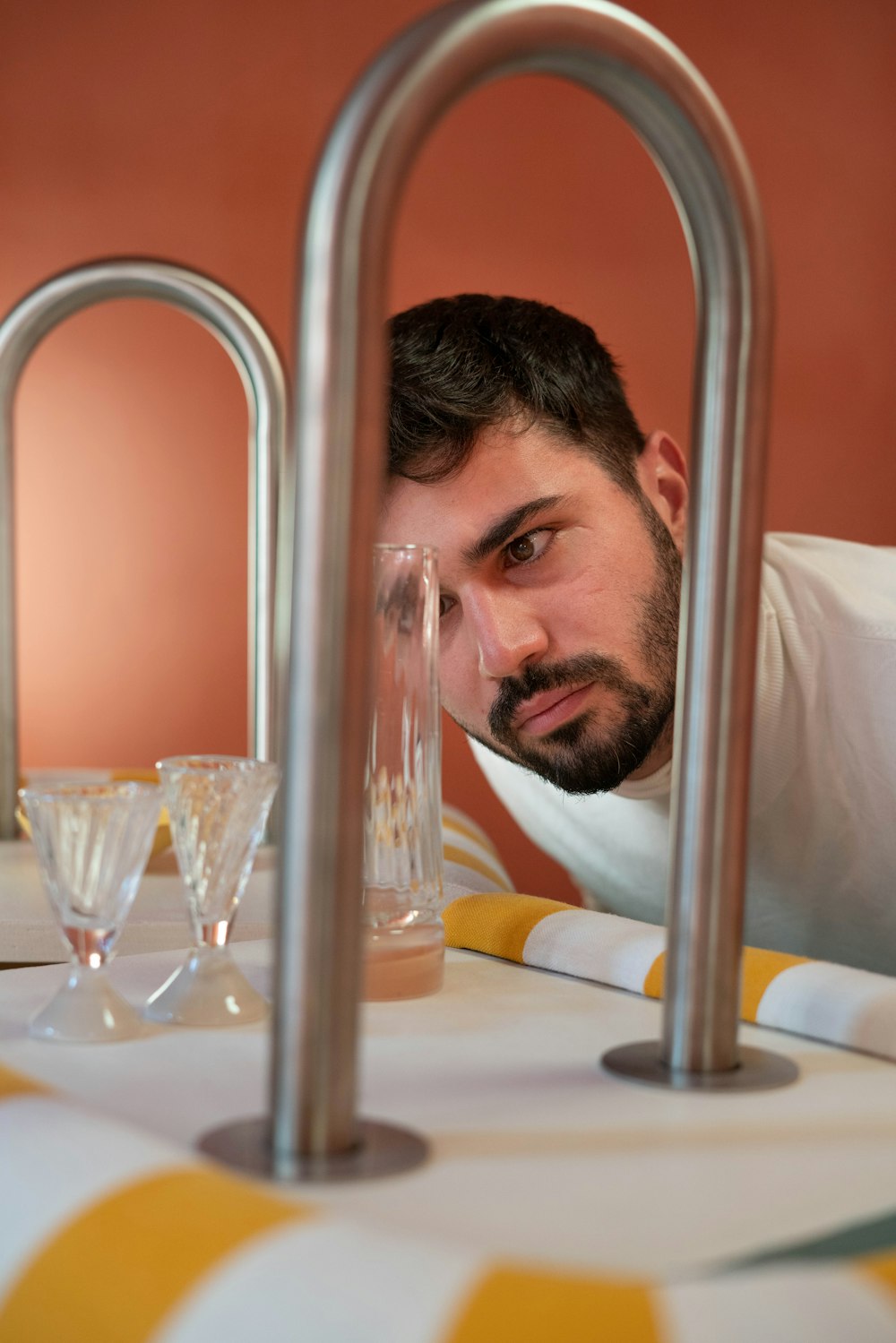 a man sitting at a table with a wine glass in front of him