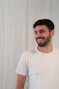 a man with a beard smiling at the camera