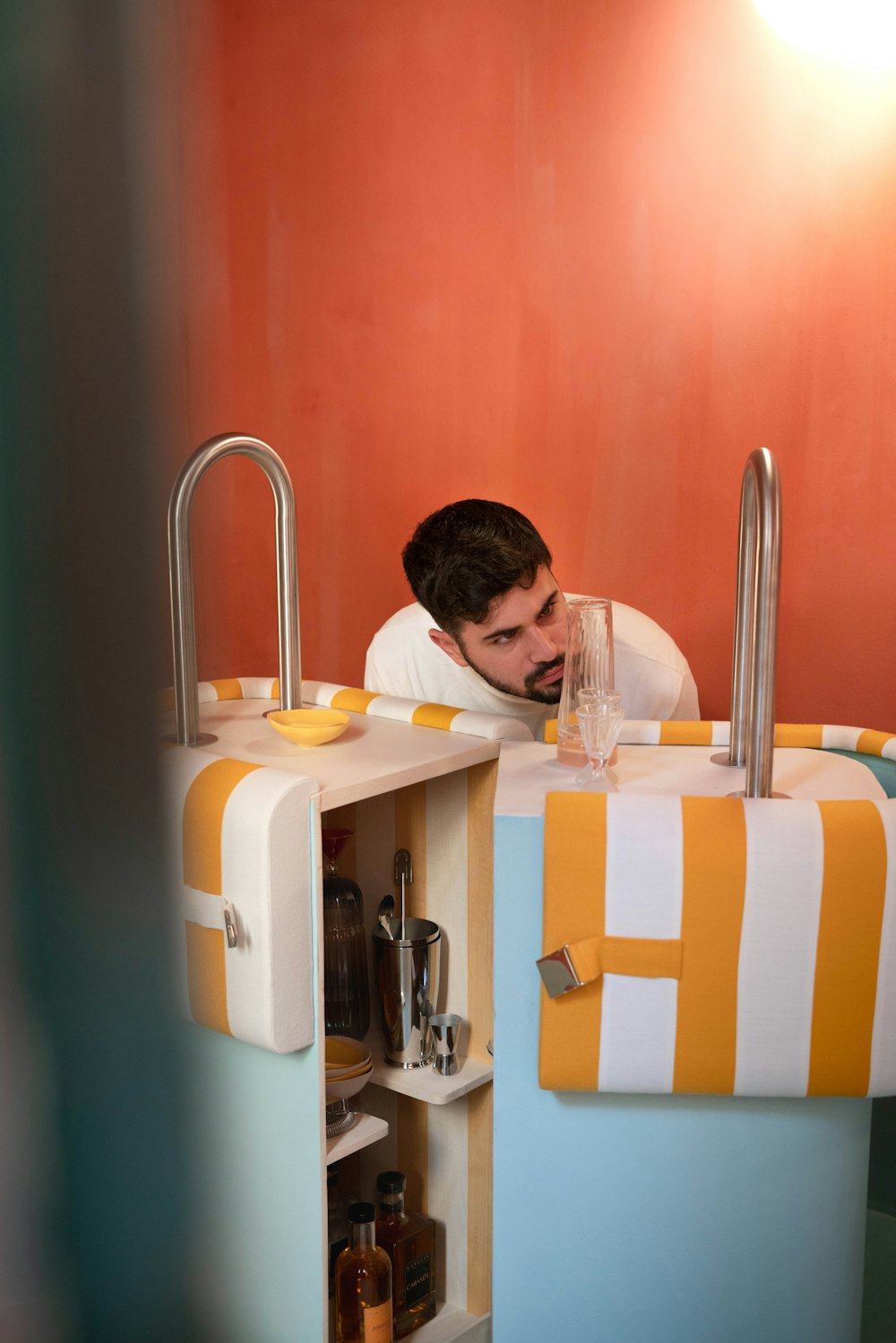 a man in a bath room with a sink