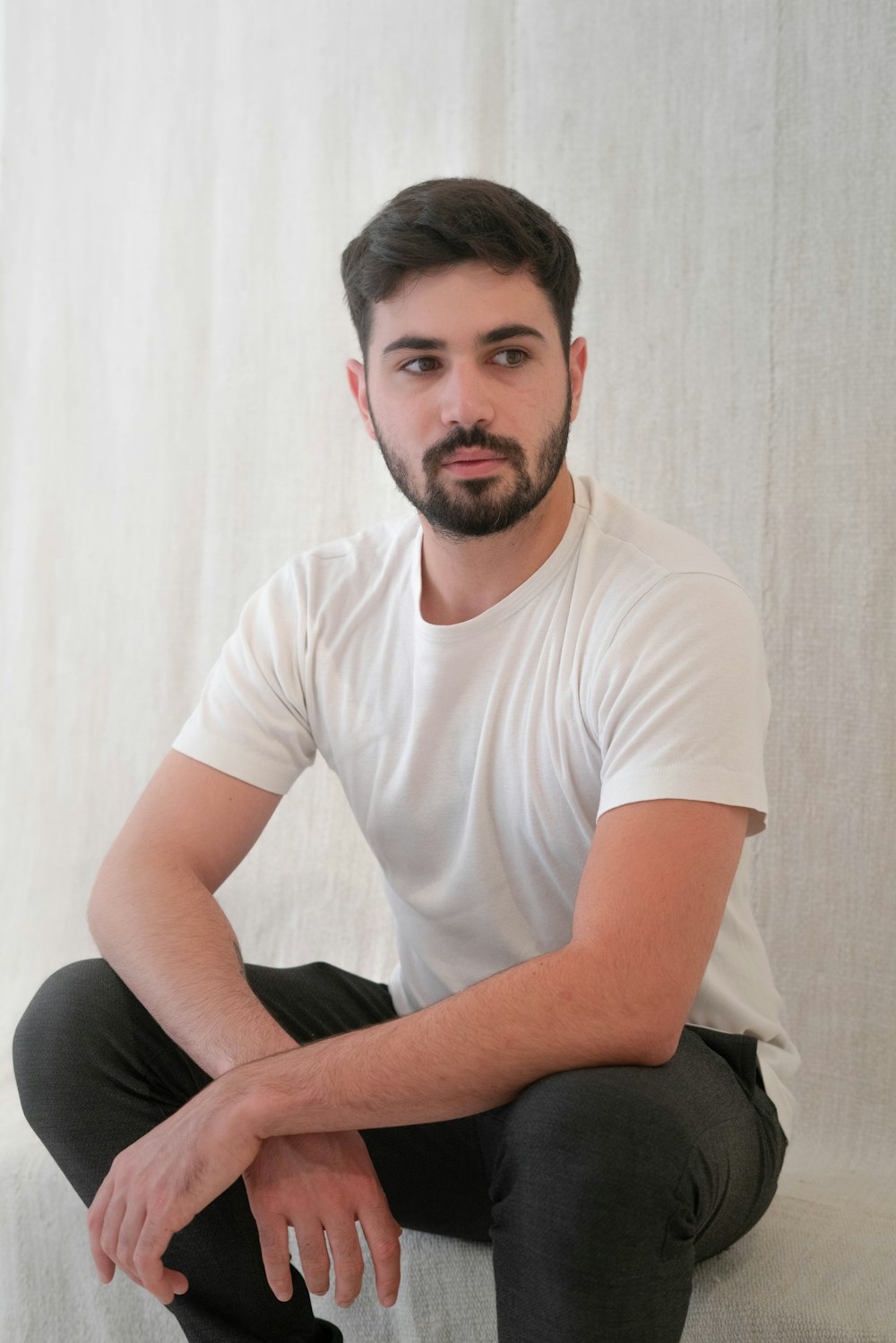 a man sitting on top of a white couch