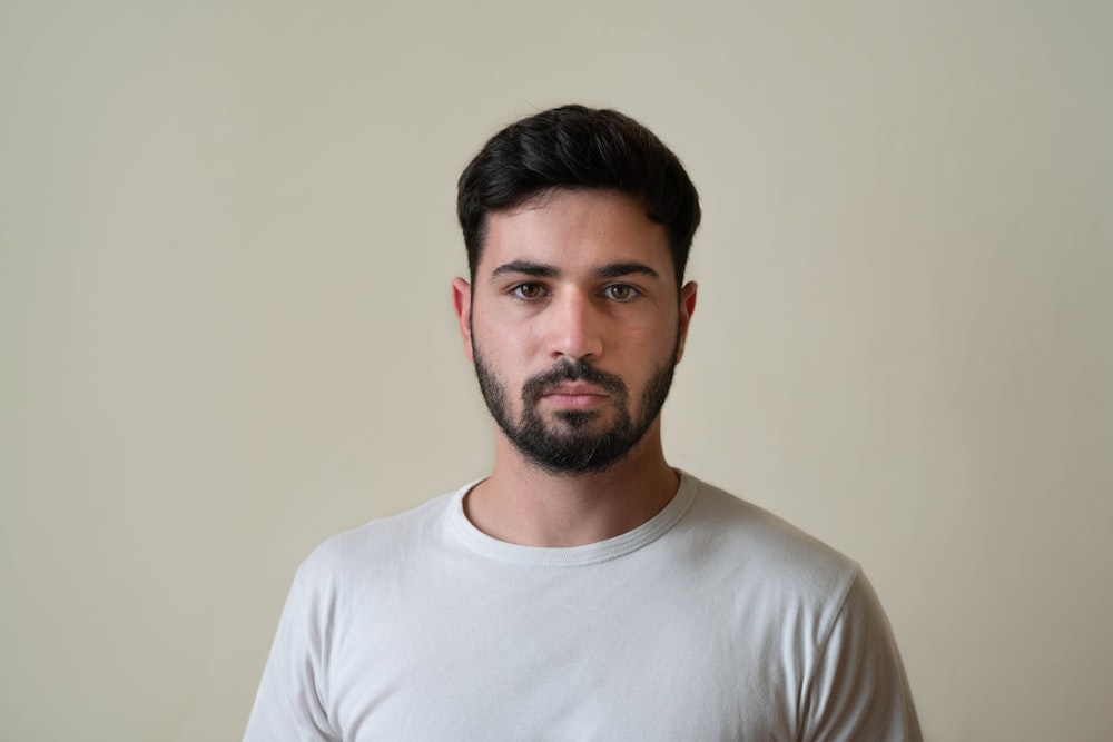 a man with a beard wearing a white shirt