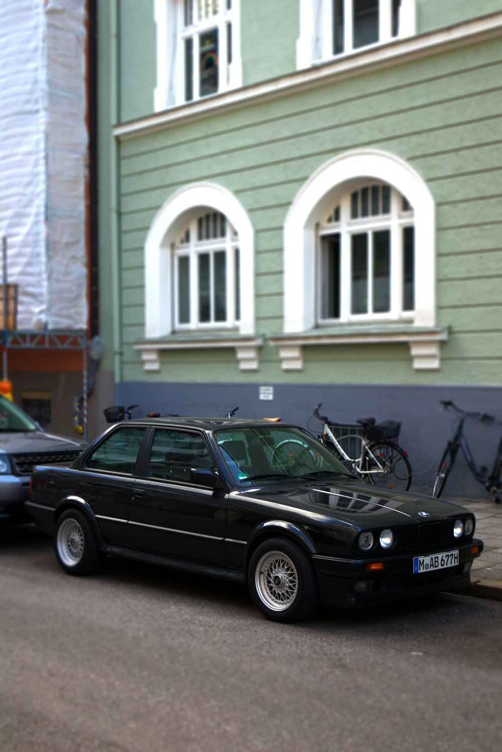 a black car parked on the side of the road