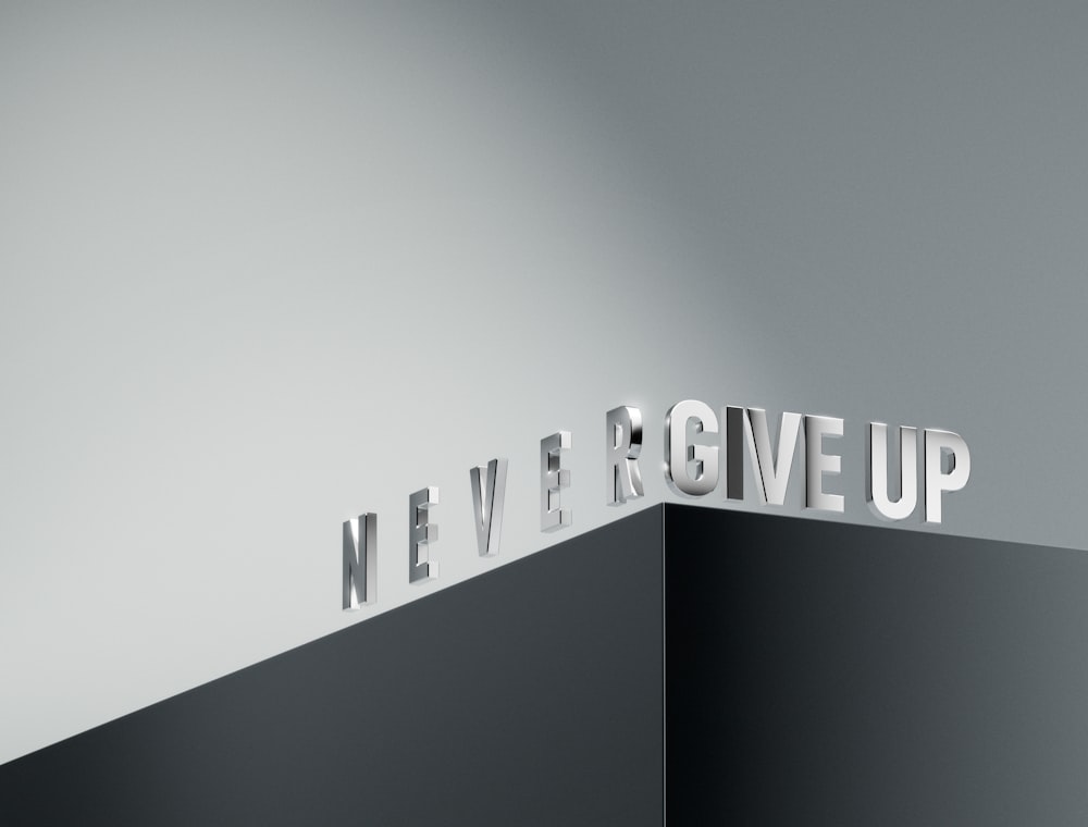 a black and white photo of the word never give up