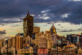 a view of a city with tall buildings under a cloudy sky