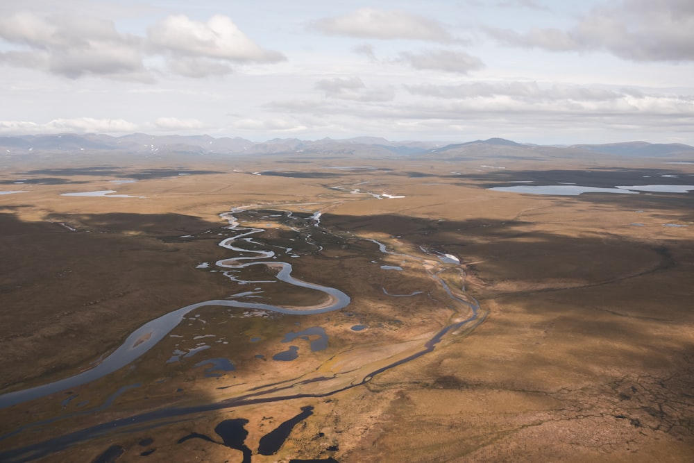 an aerial view of a river running through a plain