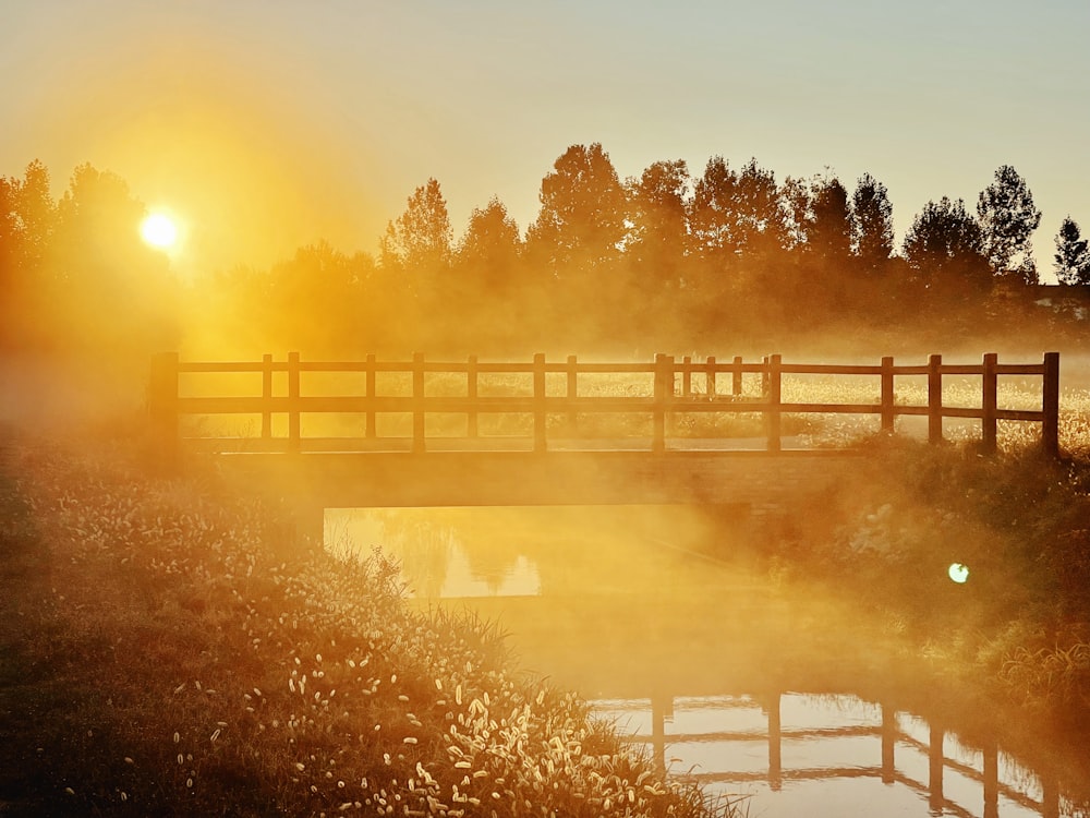 a bridge over a body of water at sunset