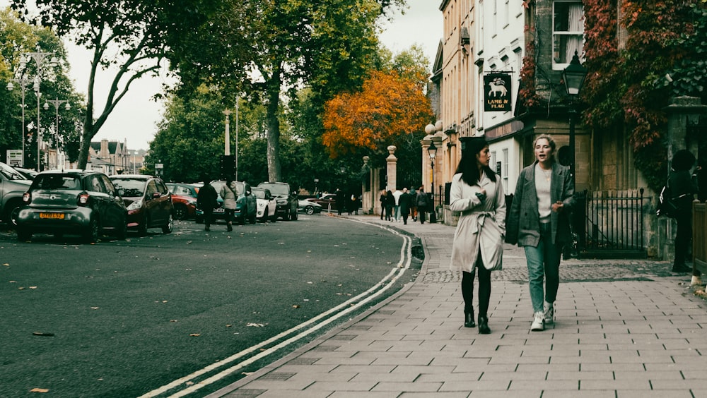 a couple of people walking down a street