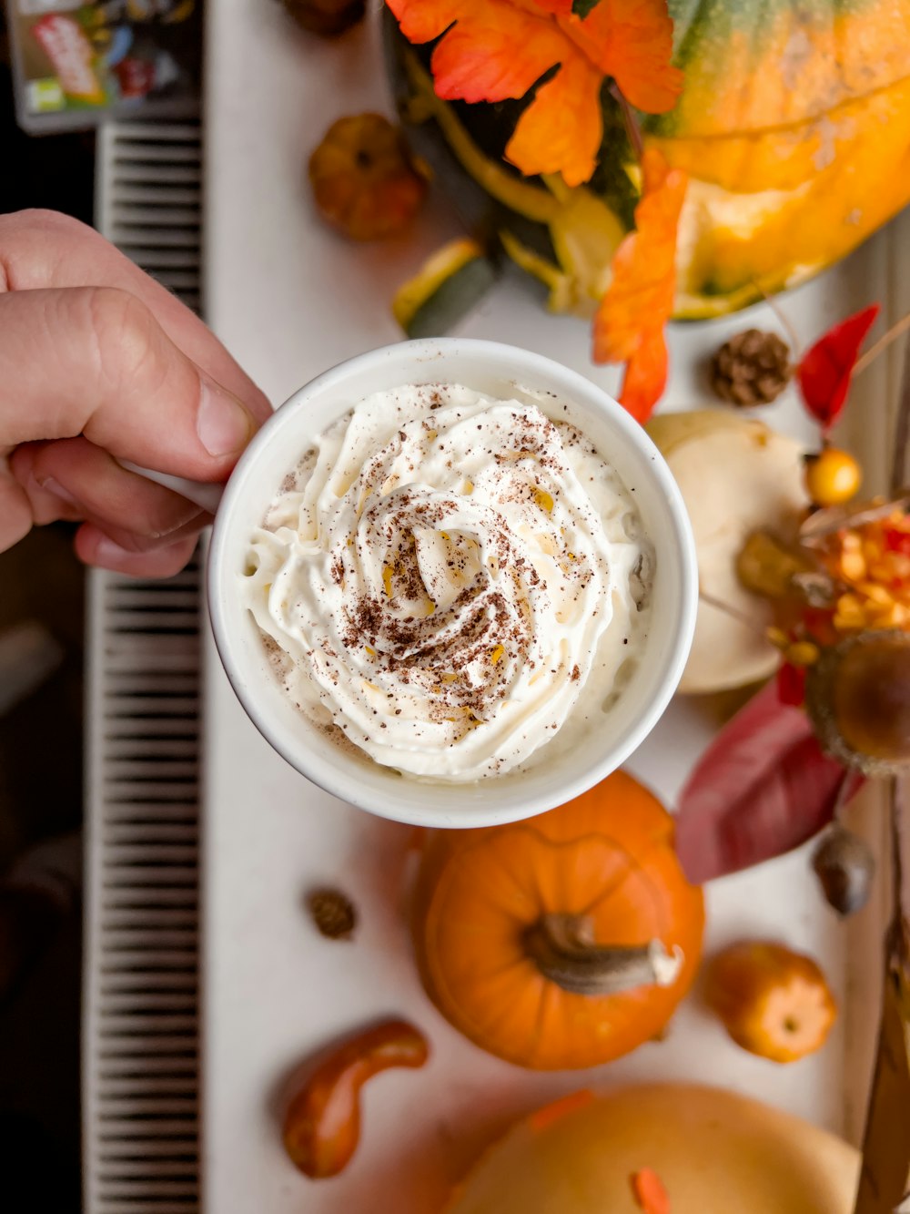 a person holding a cup of whipped cream