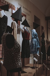 a room filled with mannequins and black hats