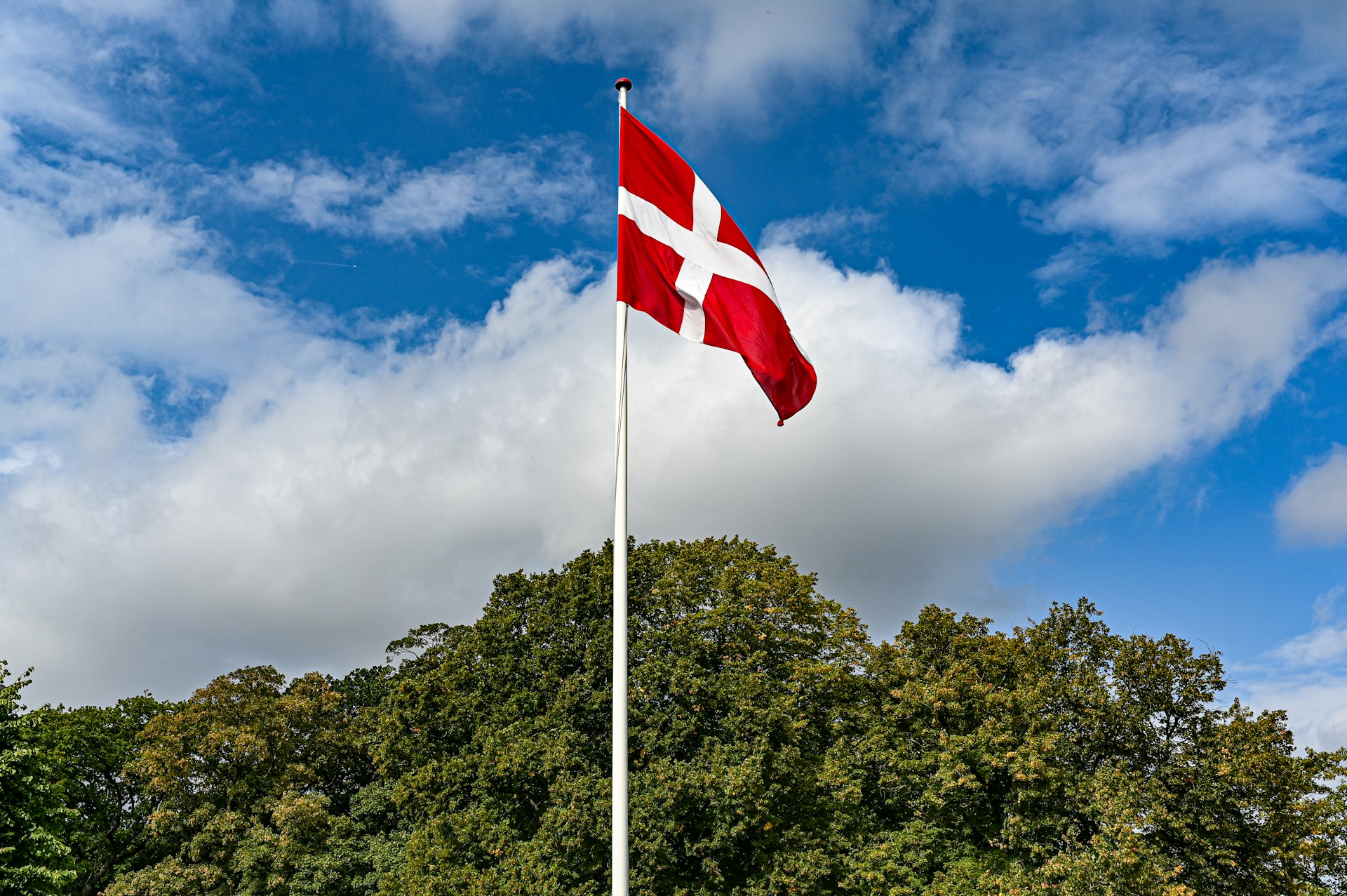 a red and white flag flying in the wind