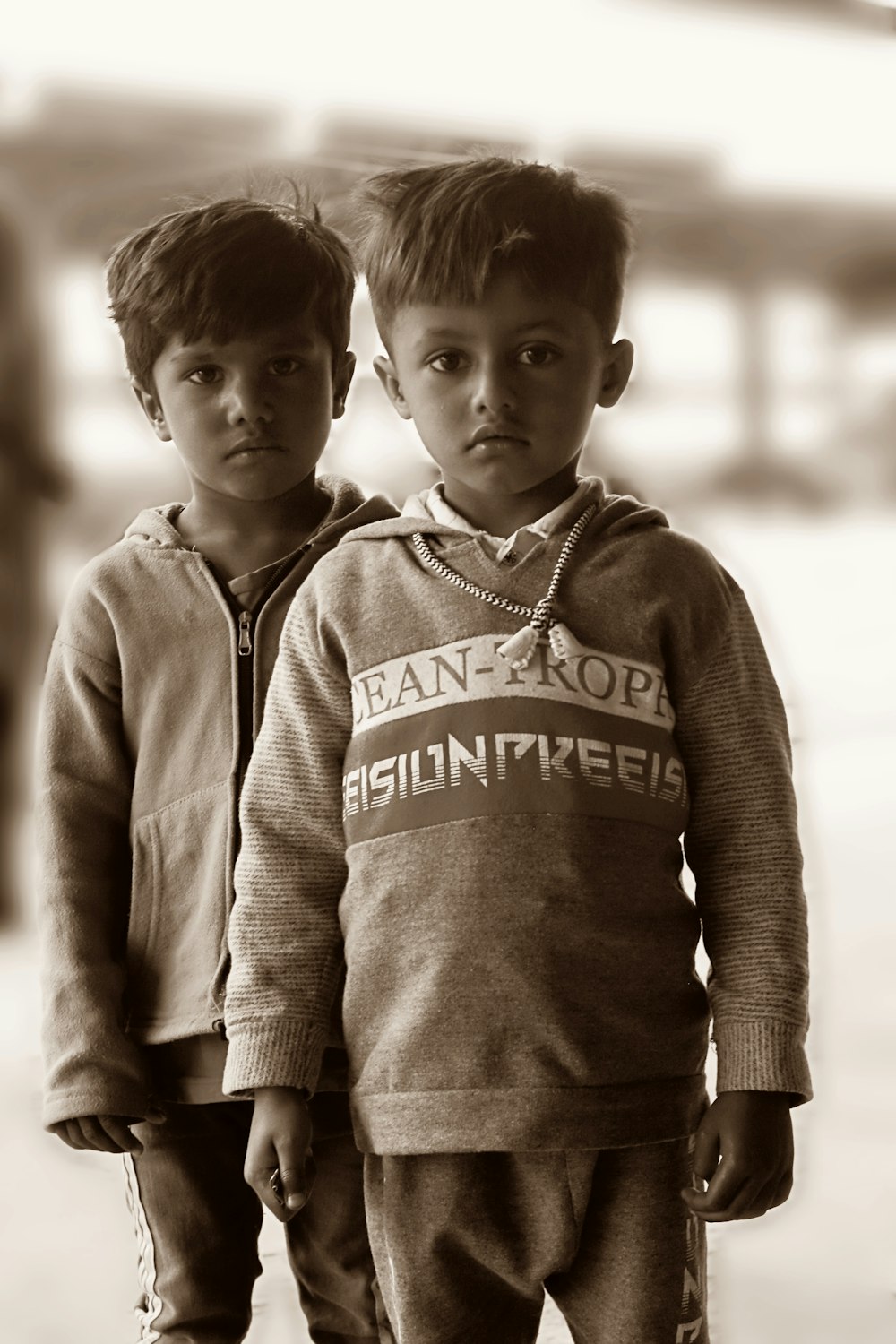 two young boys standing next to each other