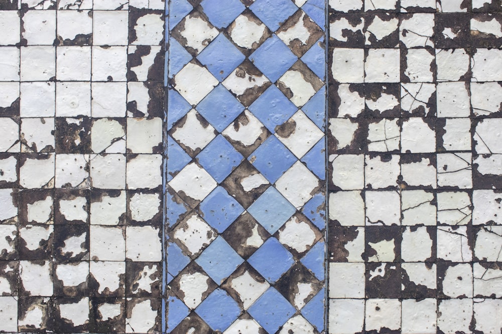 a close up of a blue and white tiled wall