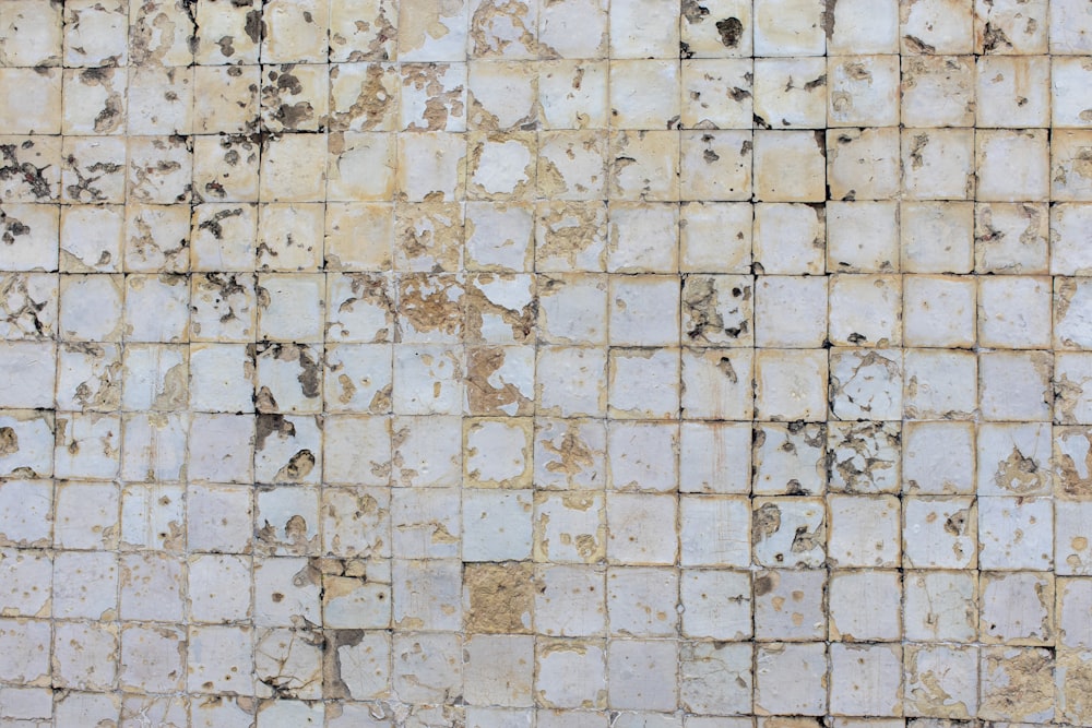 a white and brown tiled wall and floor