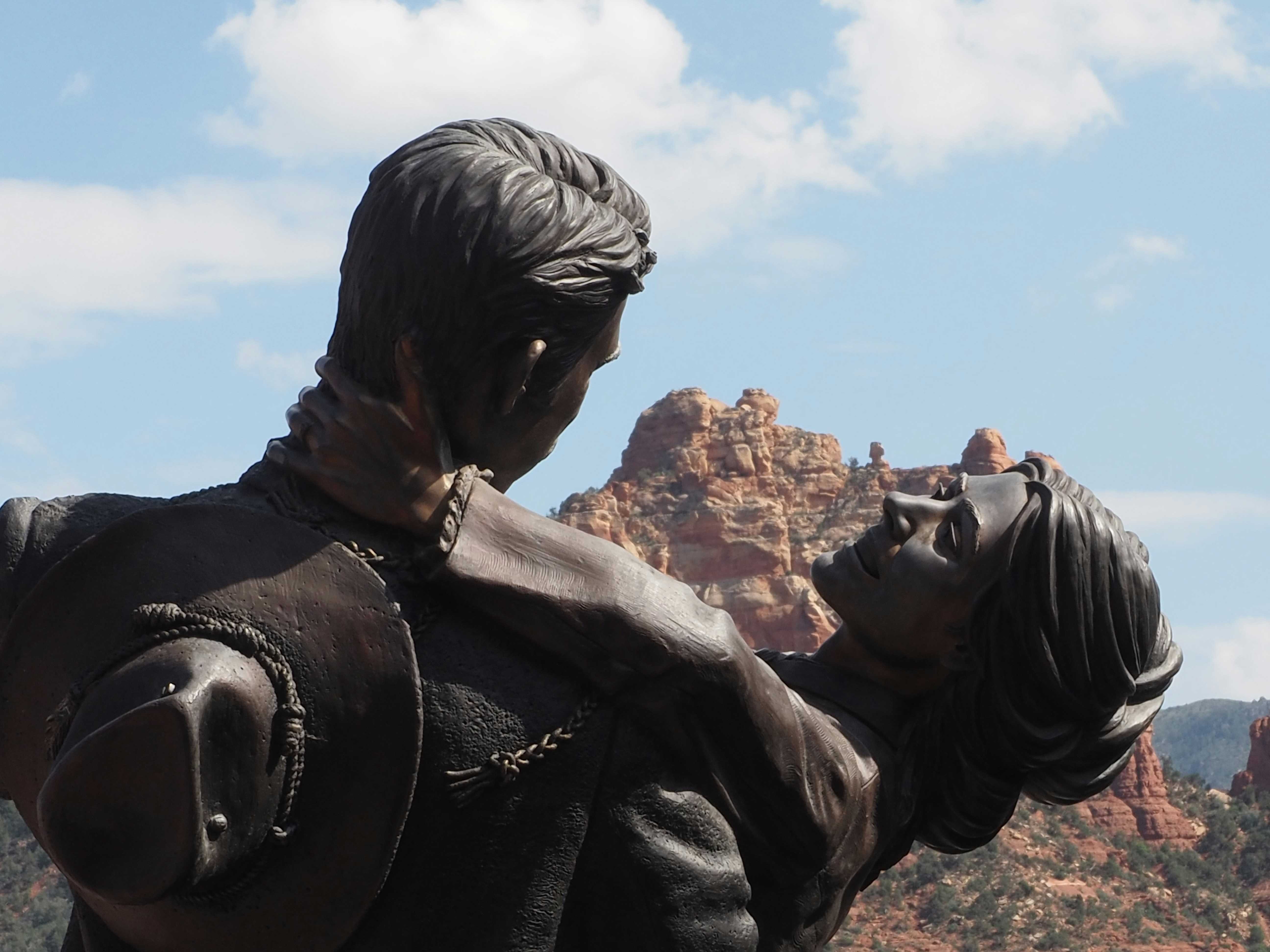 a statue of a man holding a woman