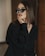 a woman in black shirt and sunglasses posing for a picture