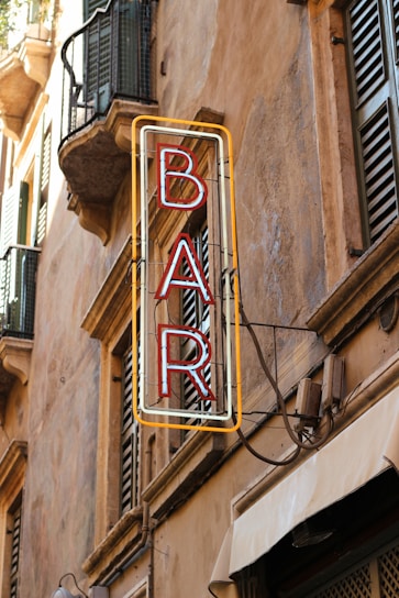 a building with a neon sign that reads paris