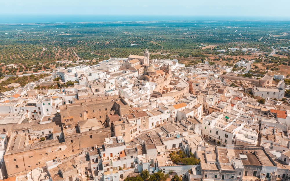 an aerial view of a city with white buildings