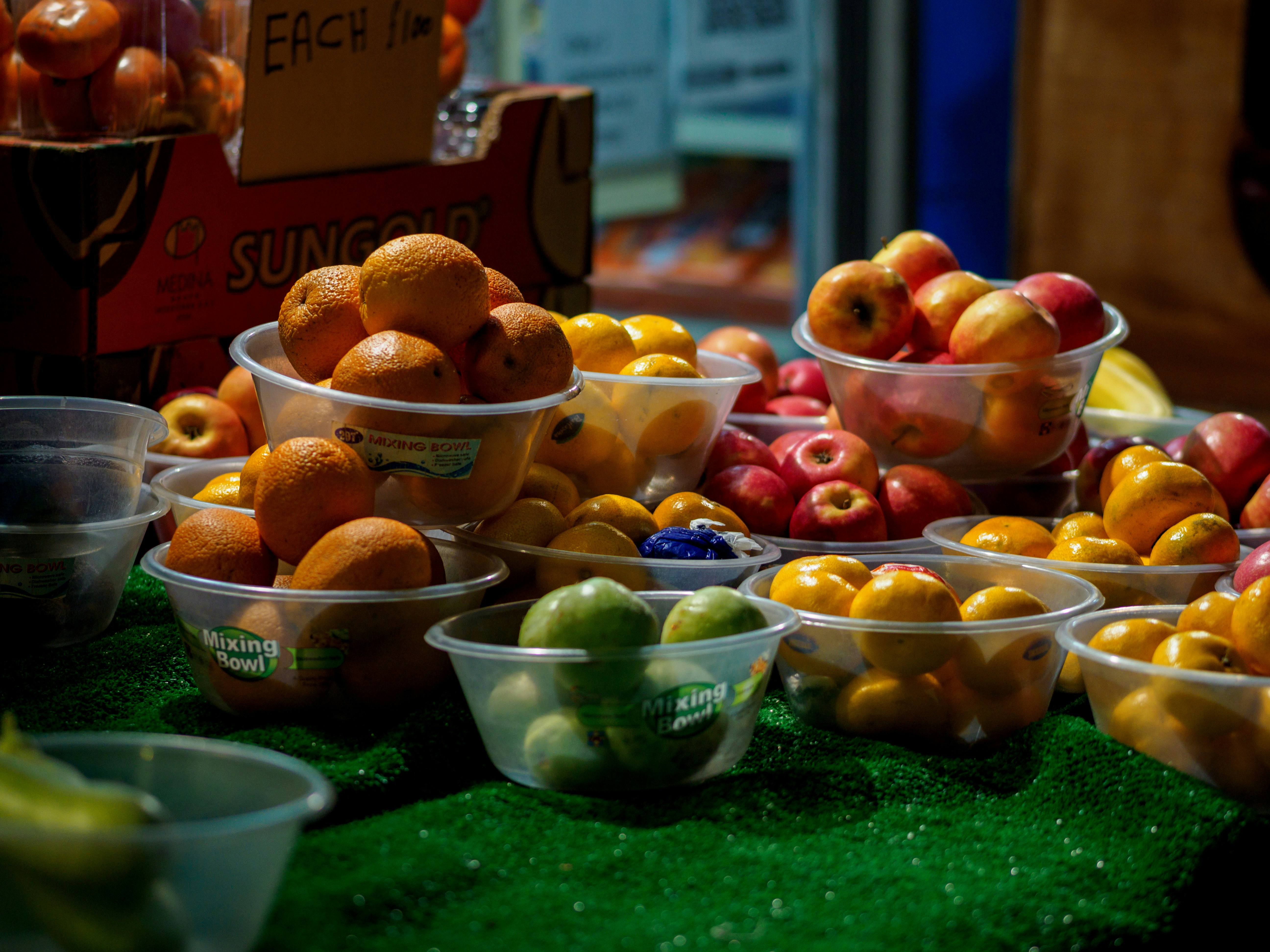 a table topped with lots of bowls filled with fruit