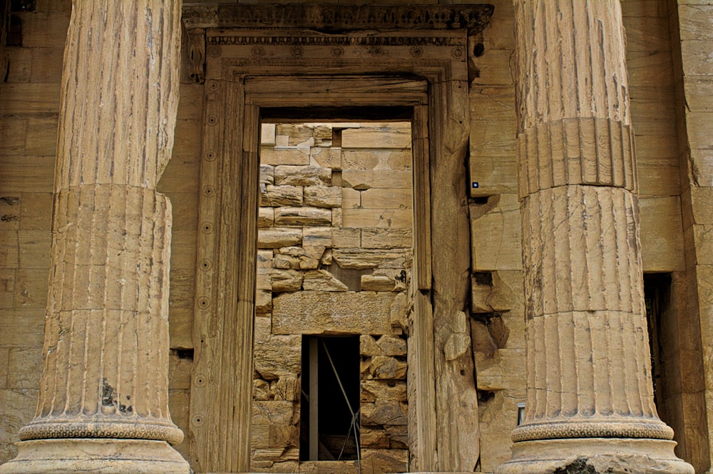 a stone building with columns and a clock