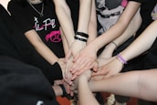 Hands joined together in a circle symbolizing mutual respect and accountability.