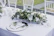 A beautifully decorated wedding table with elegant chair covers and floral centerpieces.