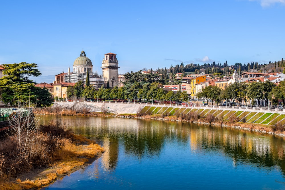 a river running through a city next to a forest