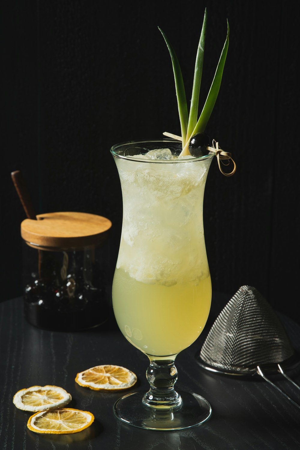 a glass filled with a lemonade cocktail next to sliced lemons