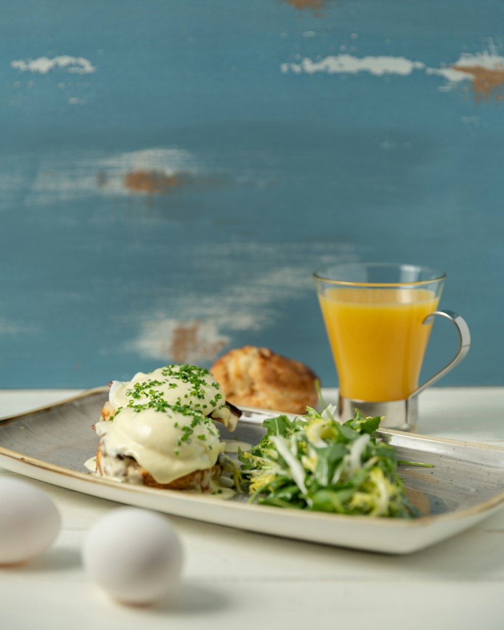 a plate of food and a glass of orange juice