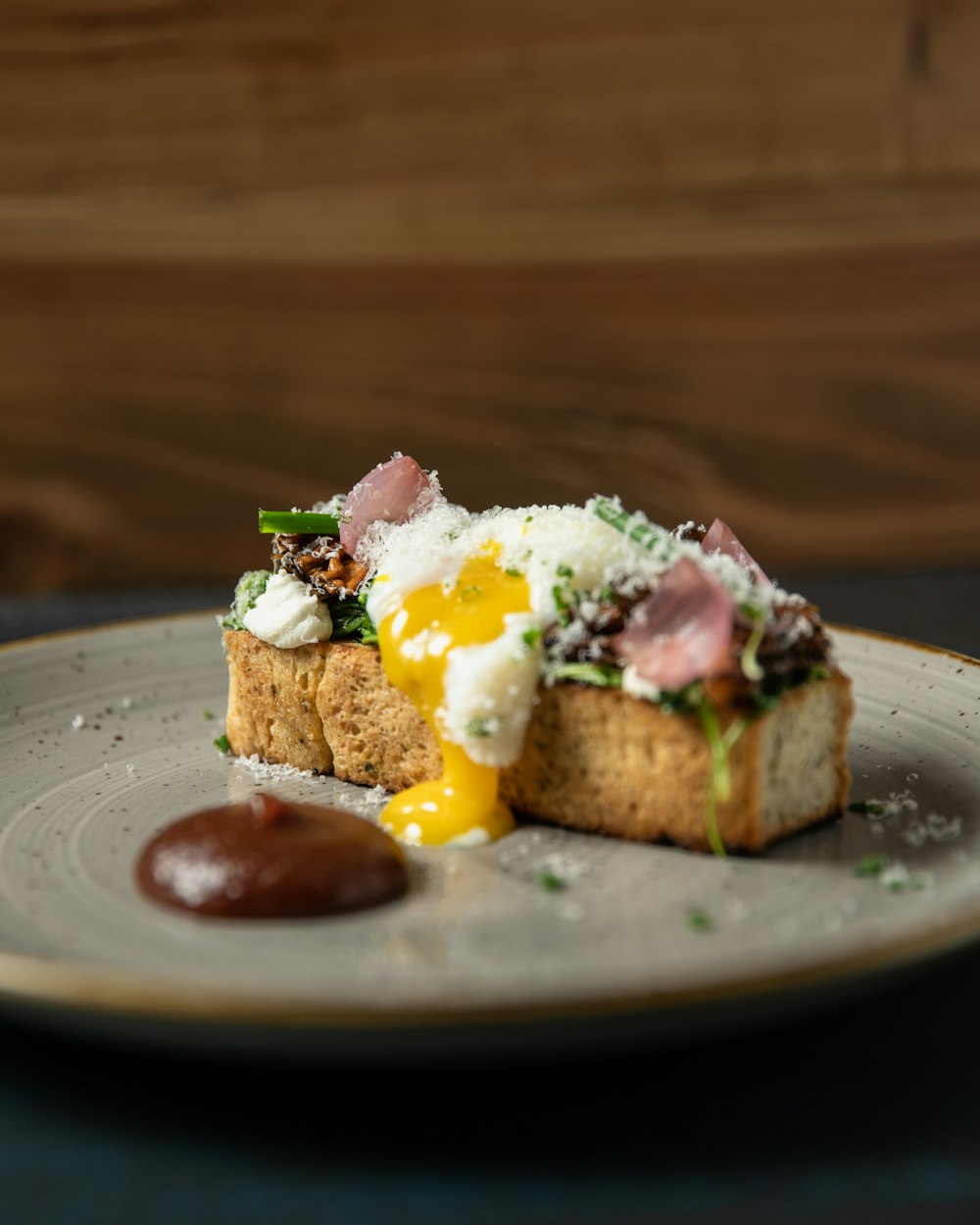 a plate with a piece of bread topped with an egg
