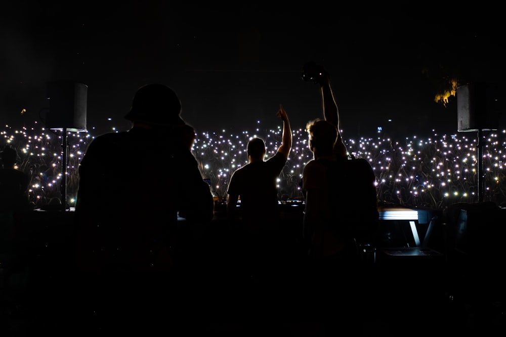 a group of people standing next to each other at night