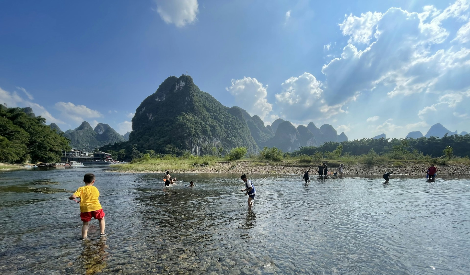 woman wearing yellow long-sleeved dress under white clouds and blue sky during daytime