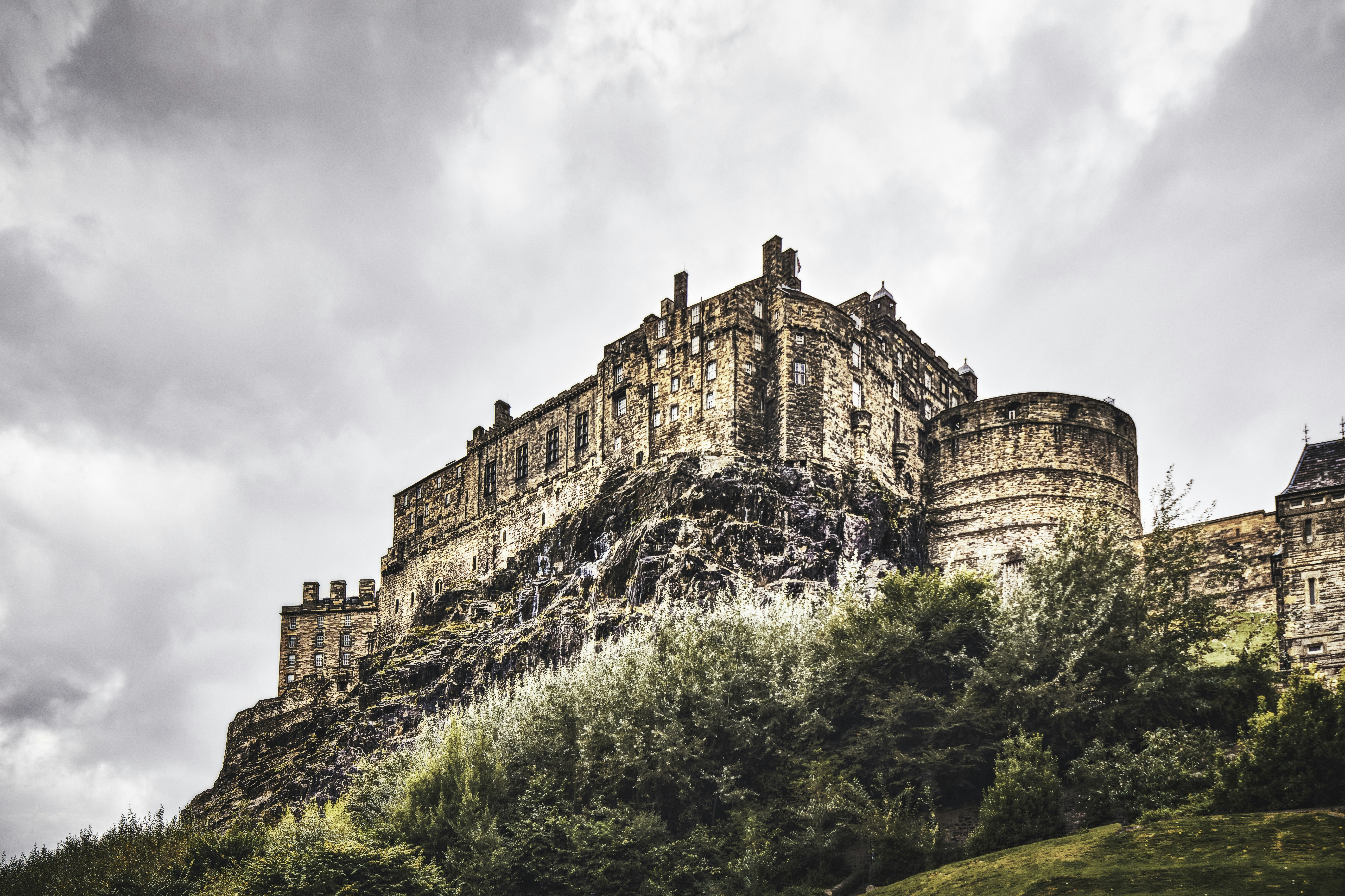 a castle on top of a hill surrounded by trees, A view of Edinburgh Castle from Old Town (Sep., 2021).