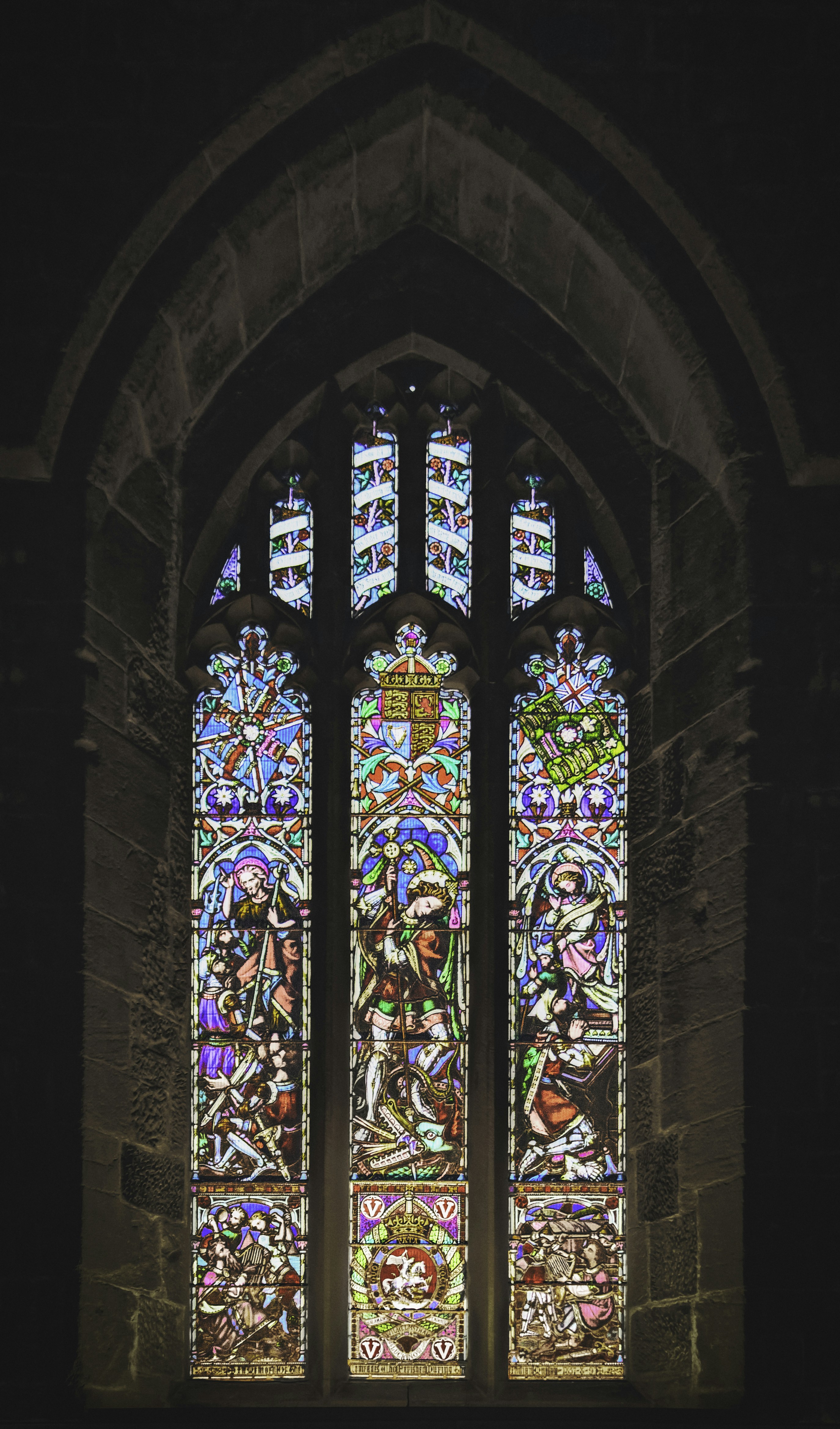 A stained-glass window depicting St. George slaying a dragon. Dragons play a dualistic role in mythology. They are both a threat and a protector--usually for valuable treasure in the case of the latter (Oct., 2021).