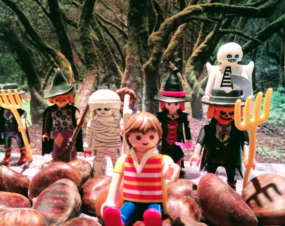 a group of toy figurines sitting on top of a pile of potatoes