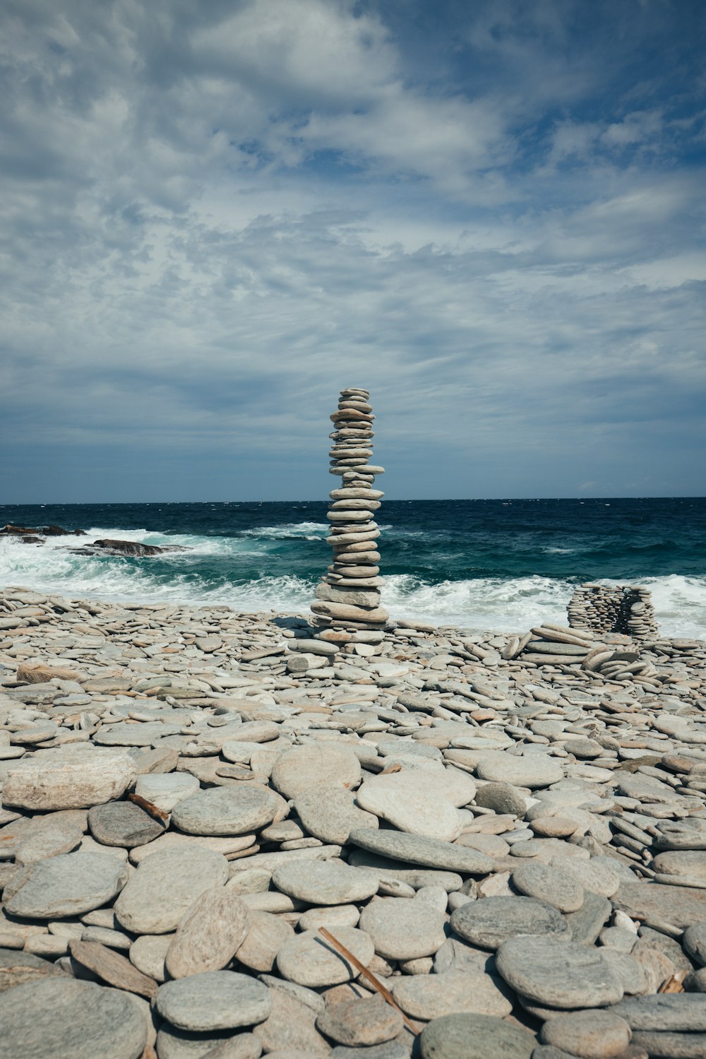 a pile of rocks sitting on top of a beach