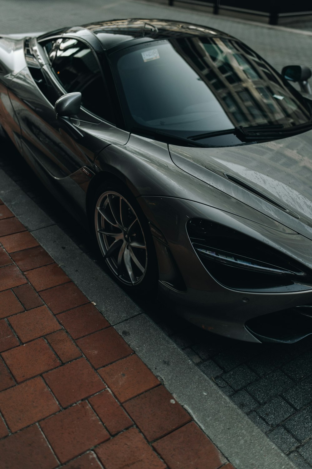 a silver sports car parked on the side of the road