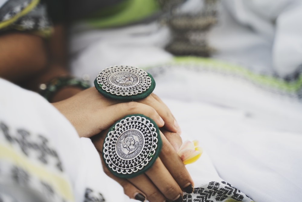 a close up of a person holding a ring