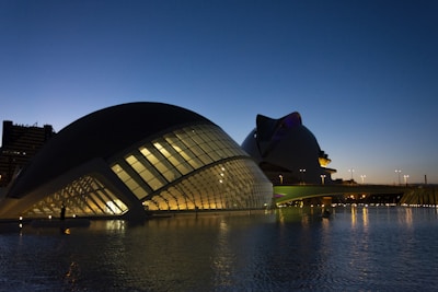 Digital rendering of a futuristic architectural concept at dusk.