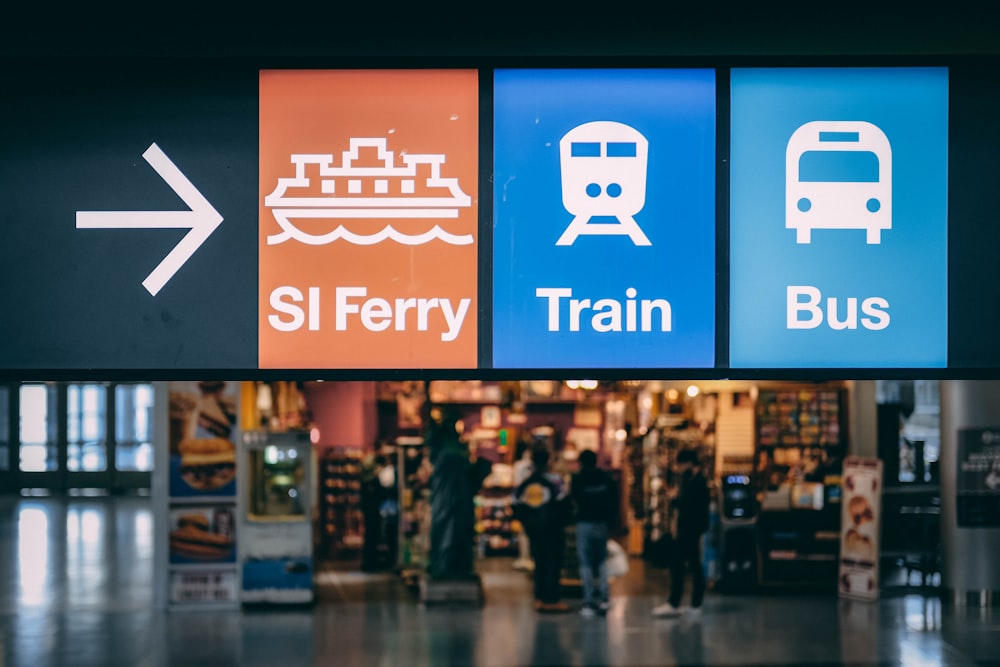 a train station with a sign that says sl ferry, train, bus