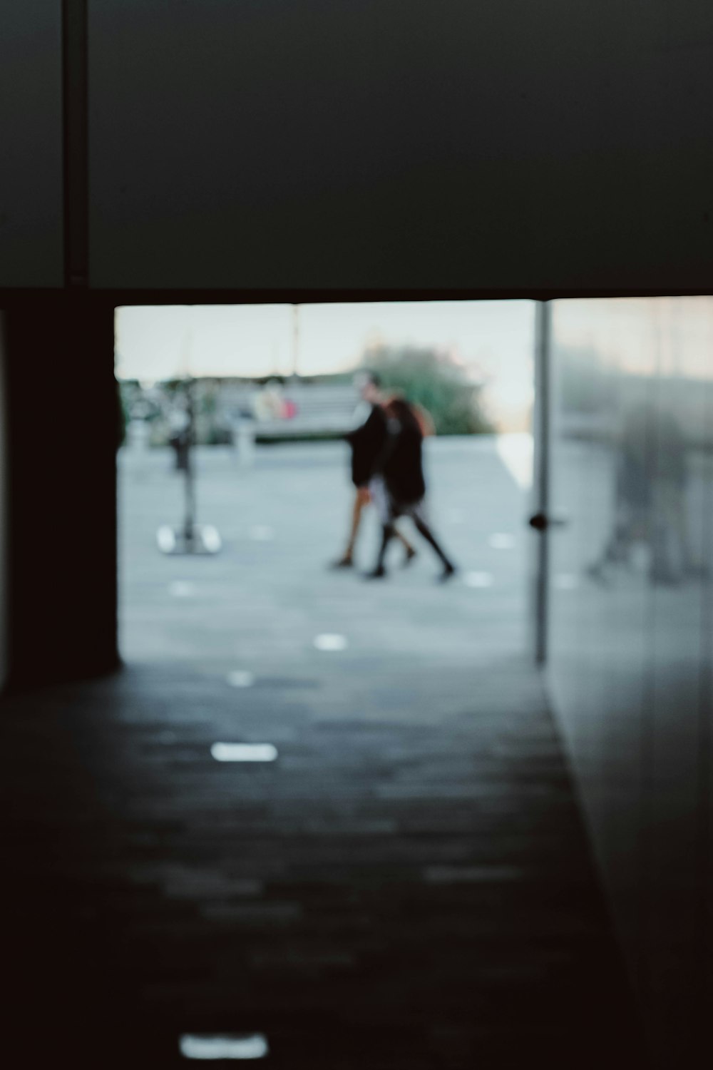 a couple of people walking down a hallway