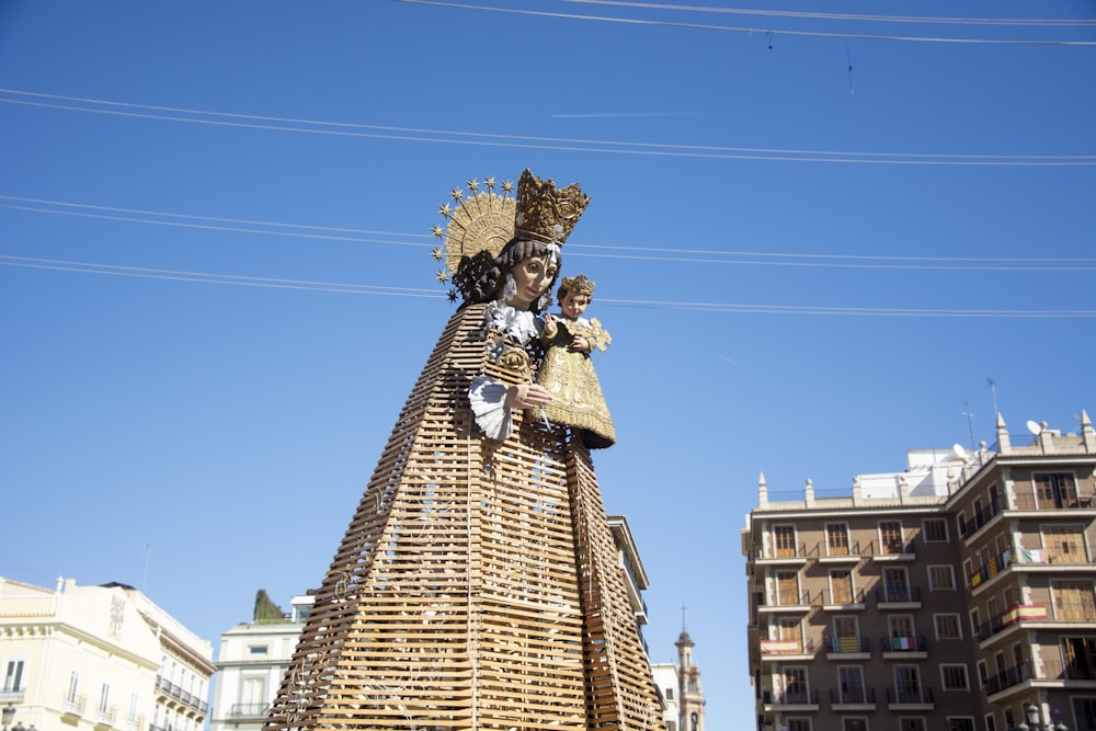 a statue of a woman holding a basket in front of a building