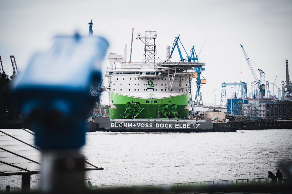 a large green and white boat in the water