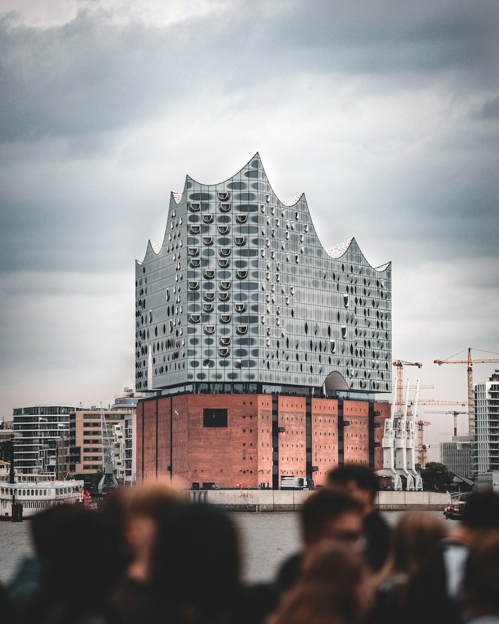 a crowd of people standing in front of a tall building