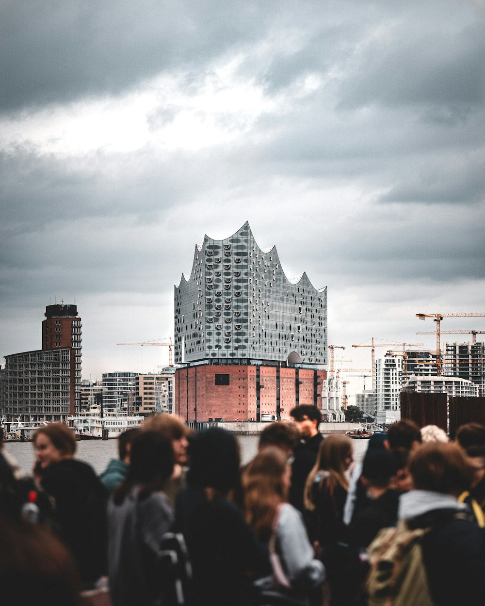 a crowd of people standing in front of a tall building