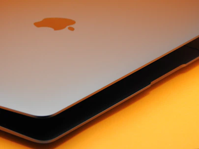 Close-up of a MacBook being opened for screen replacement by a skilled technician.