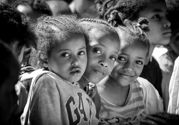 a group of young girls standing next to each other