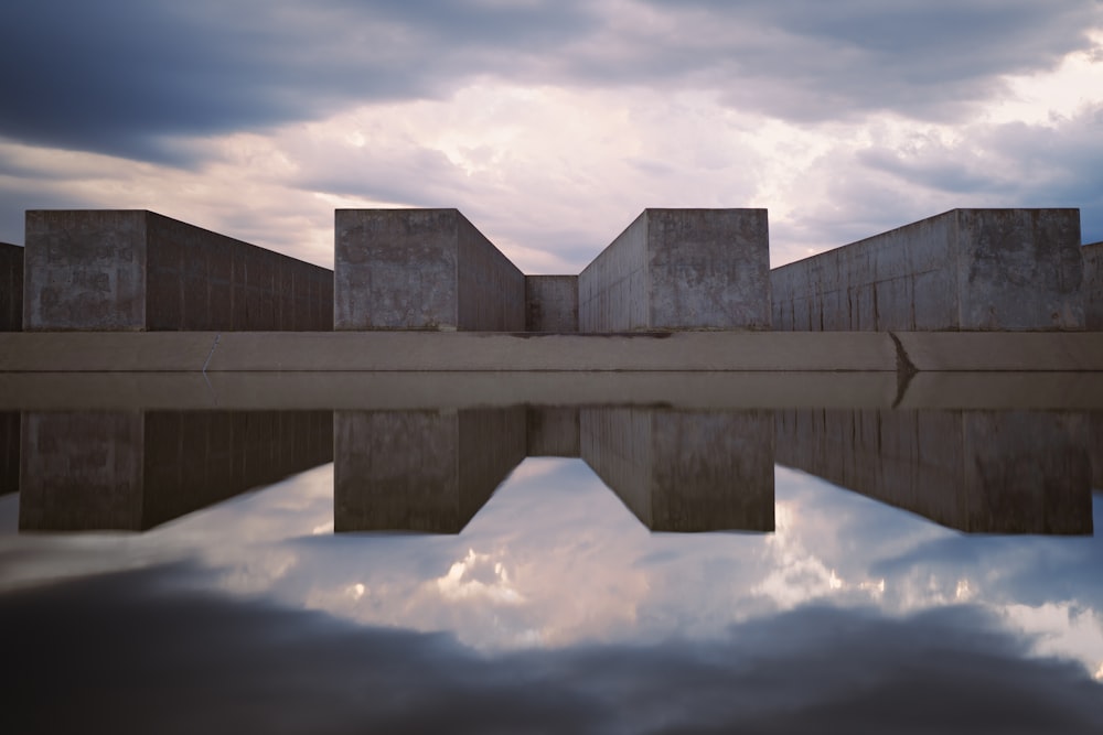 a reflection of a building in a body of water