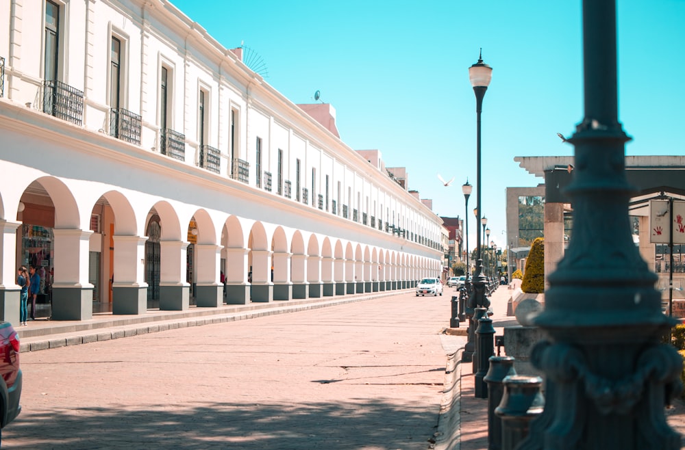 a city street lined with tall white buildings