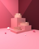 A minimalist scene with a pink and burgundy color scheme featuring geometric shapes, including a stepped platform and several scattered spheres.
